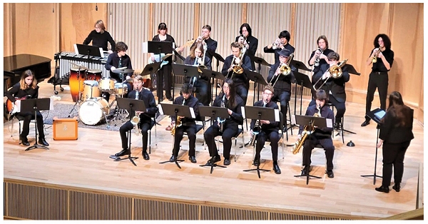 students on stage playing music
